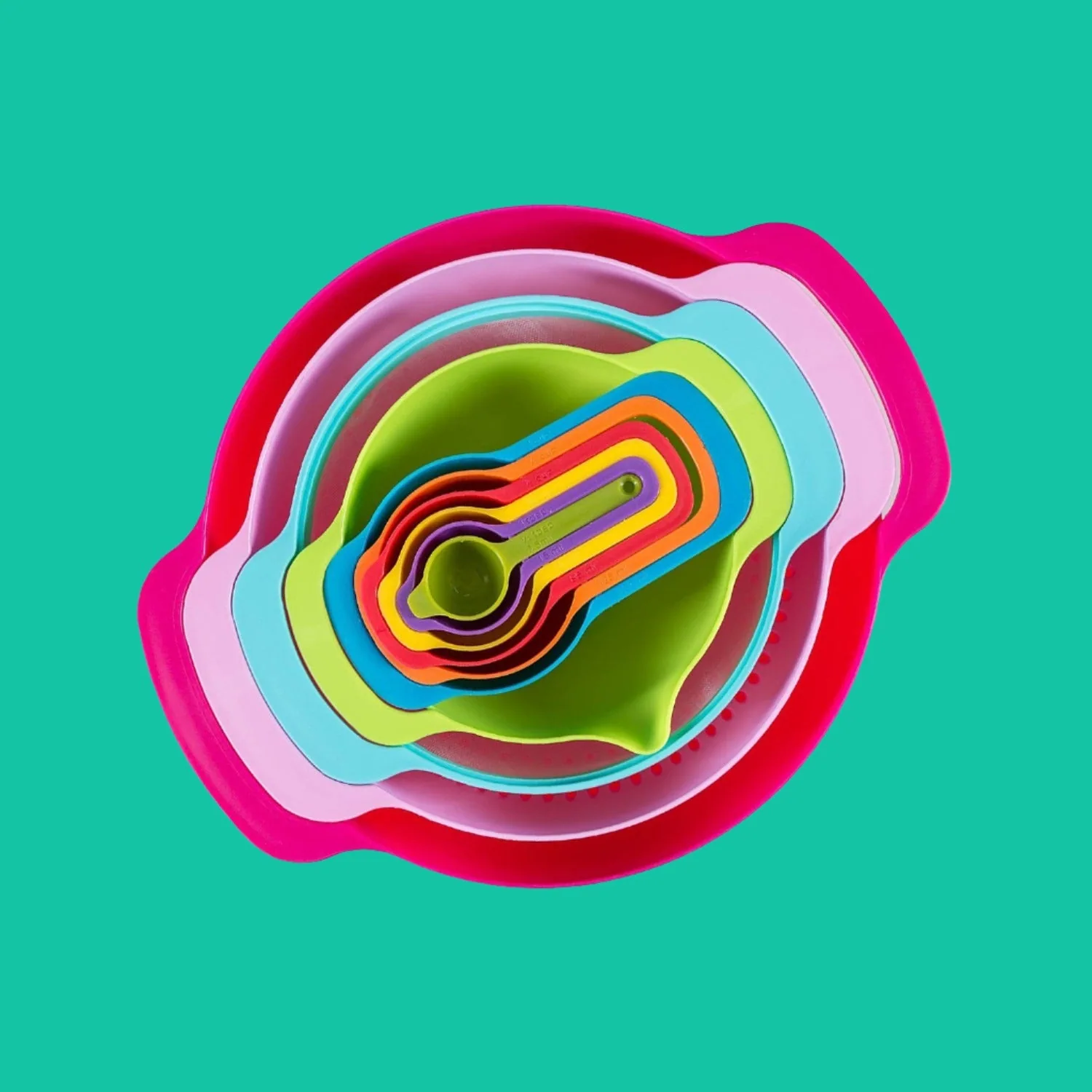 Brightly coloured mixing bowls, colander, sieve and measuring pieces nested together on a turquoise background