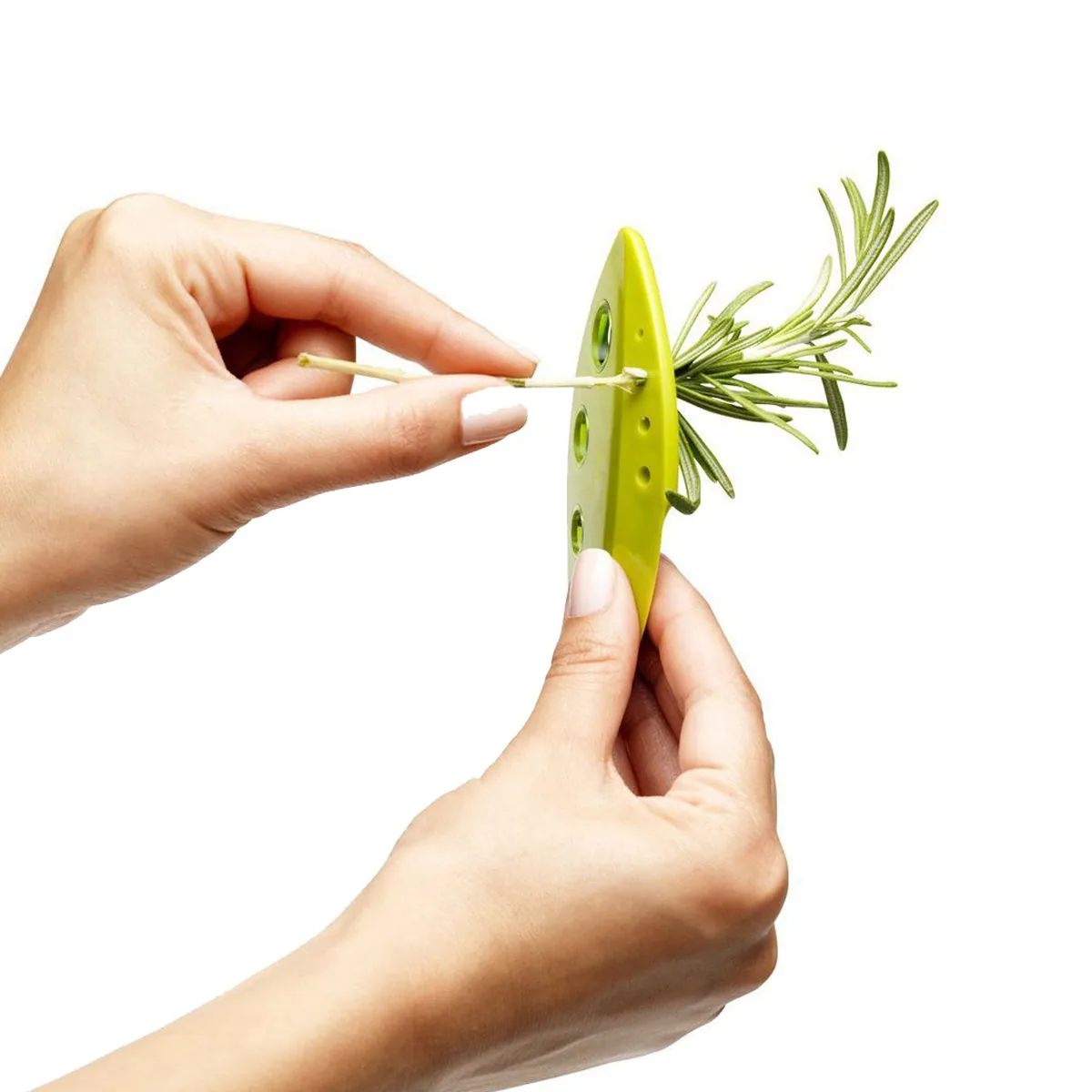 Hands pulling a rosemary stem through a hole in a bright green leaf-shaped herb stripper
