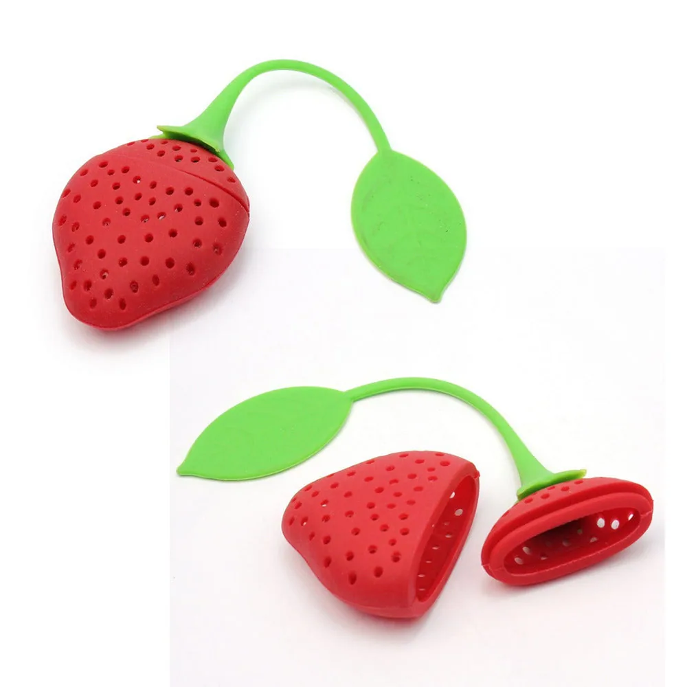 Red strawberry-shaped tea infuser with a green leaf tab, shown closed and opened on white